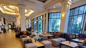 A spacious lobby with multiple seating areas, large windows, and a reception desk. - Tara Angkor Hotel (Siem Reap)