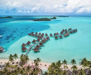 An overwater bungalows arrangement with a beach and palm trees. - InterContinental Bora Bora Le Moana Resort by IHG (Bora Bora)