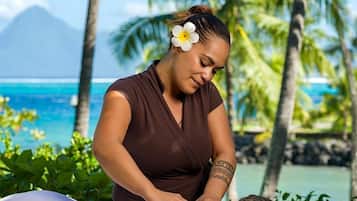 Experience a rejuvenating massage amidst lush greenery and ocean views.