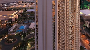 A high-rise hotel with multiple floors, a rooftop pool, and a landscaped courtyard.