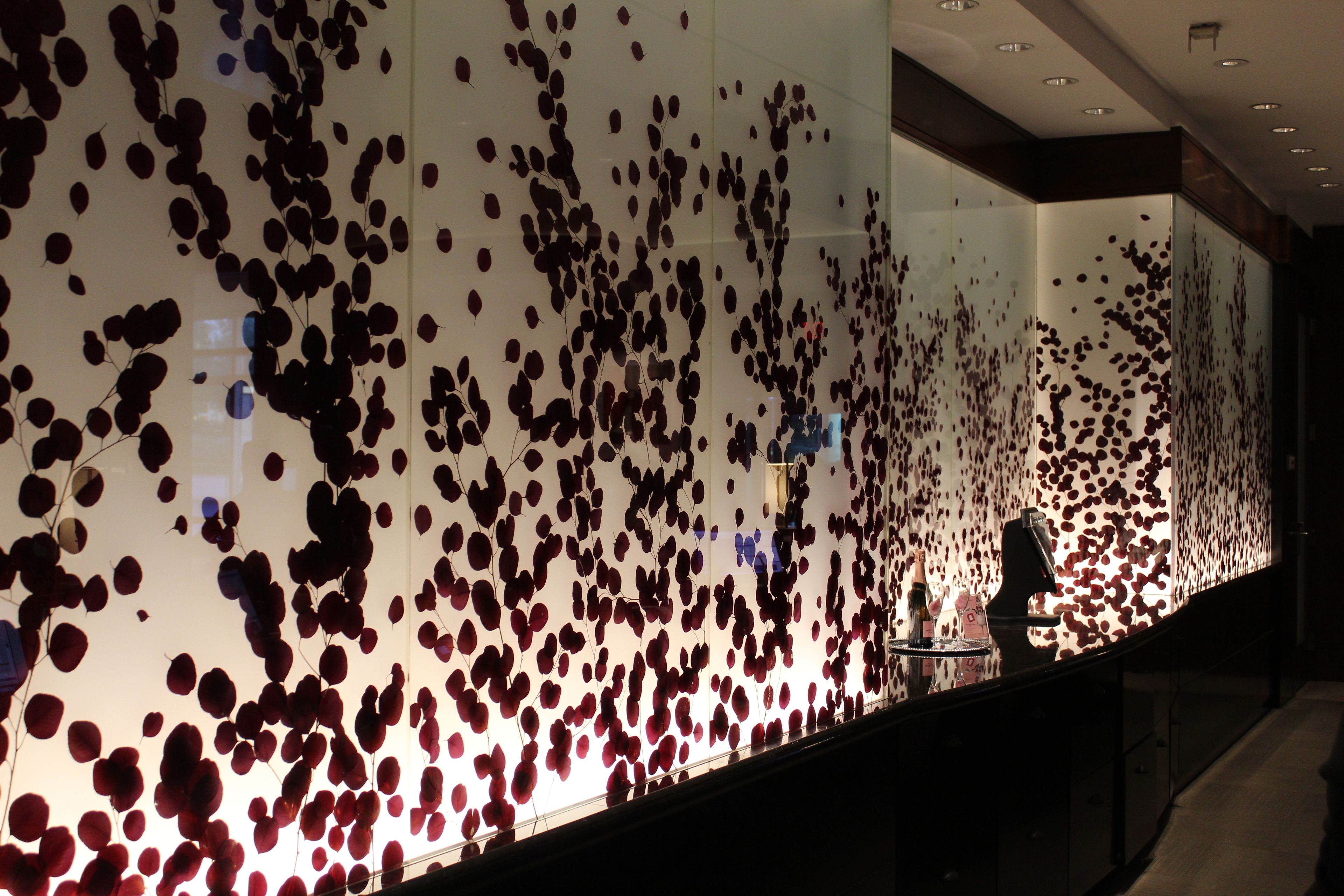 A wall with a pattern of red and black circular shapes.