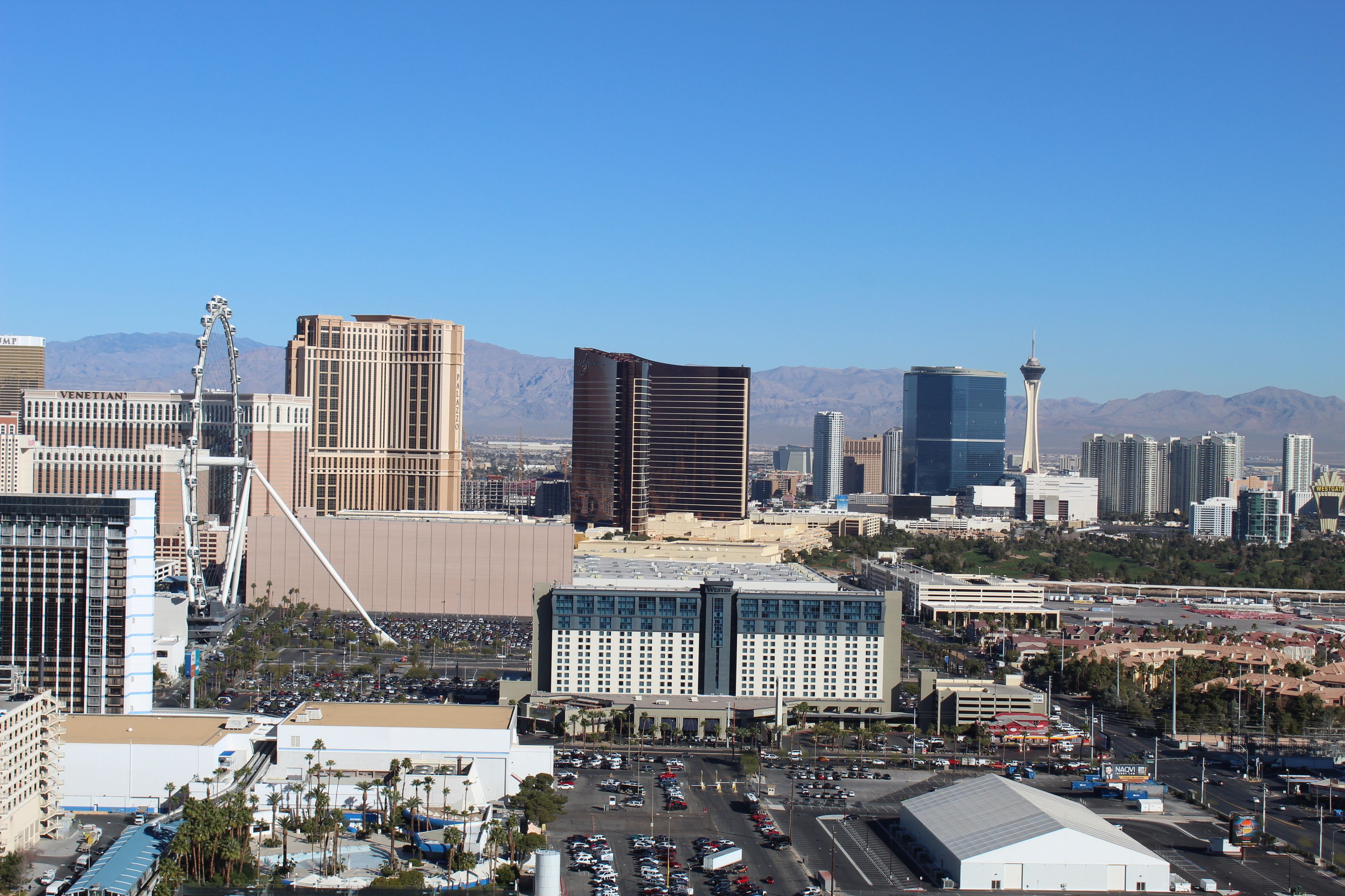A cityscape with modern buildings, a prominent tower, and a clear sky.