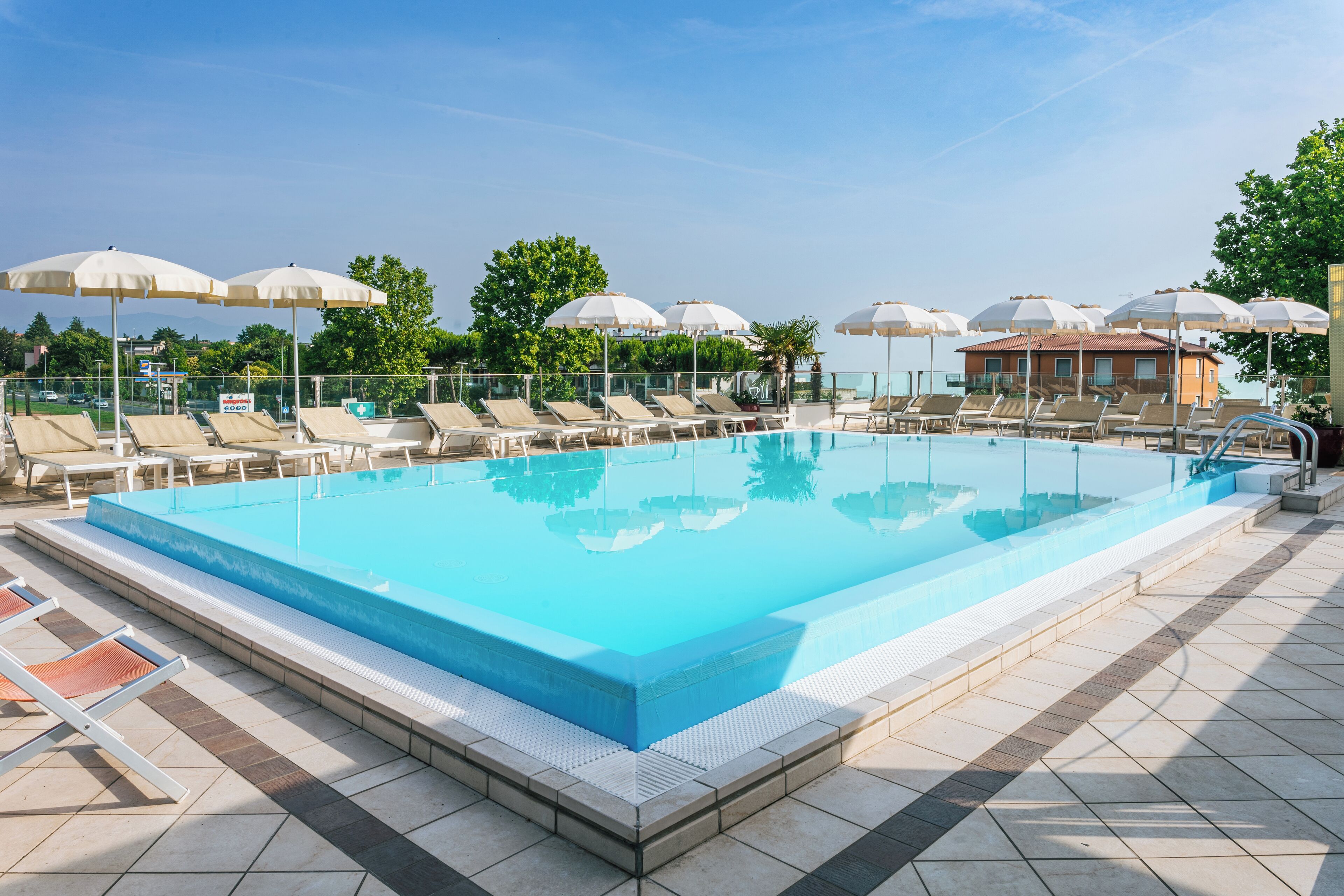 Seasonal outdoor pool, open 9:00 AM to 8:00 PM, pool umbrellas