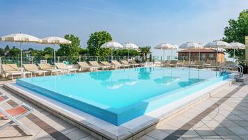Seasonal outdoor pool, open 9:00 AM to 8:00 PM, pool umbrellas