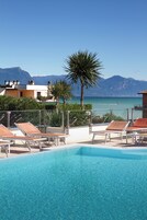 Seasonal outdoor pool, open 9:00 AM to 8:00 PM, pool umbrellas