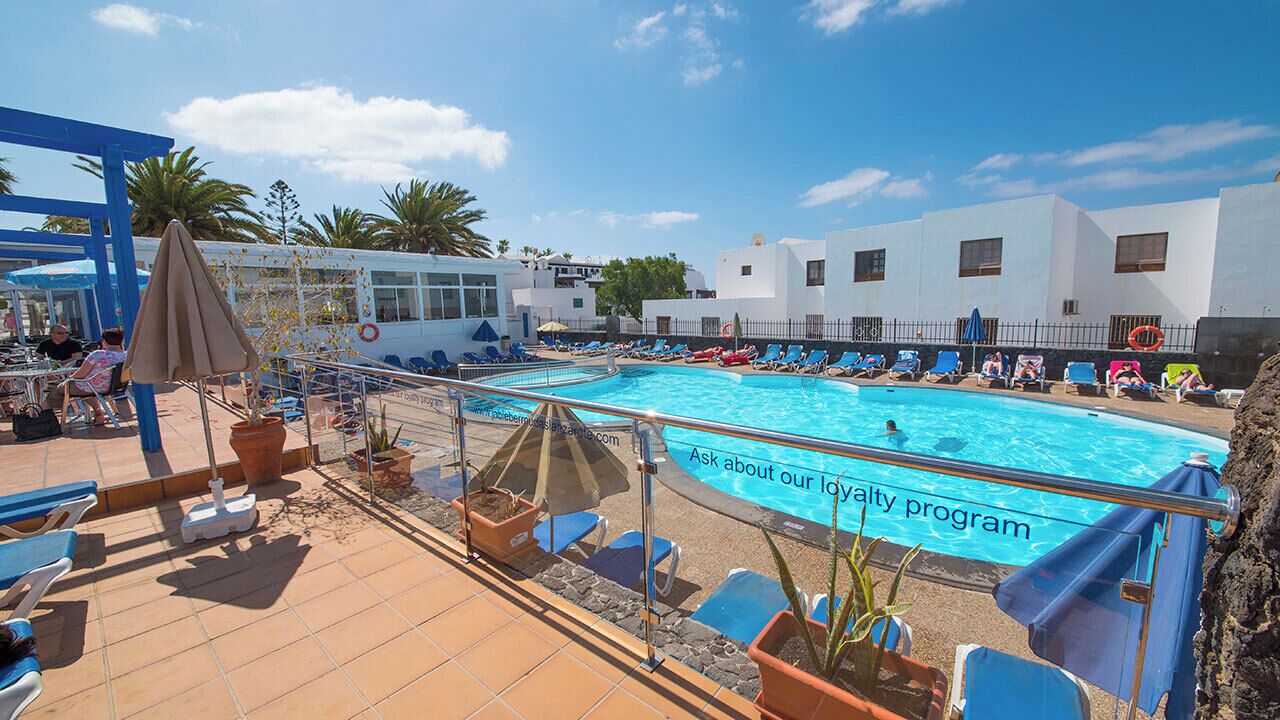 A pool area with multiple pools, lounge chairs, and a lifebuoy.