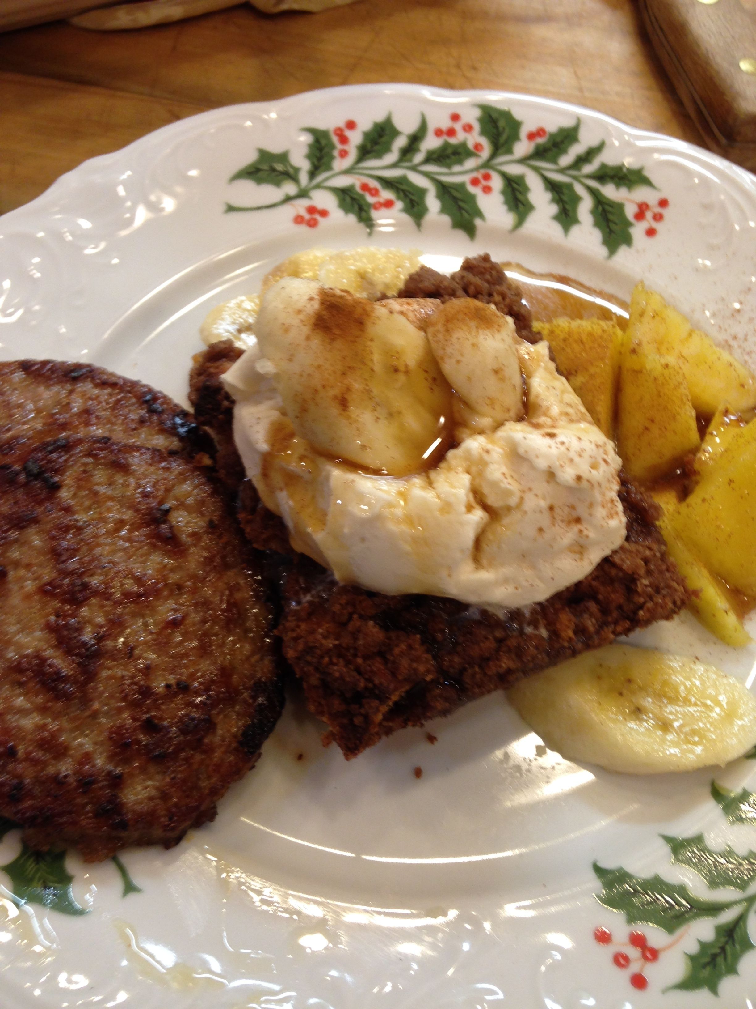 A plate with a slice of cake, a scoop of ice cream, and a grilled patty.