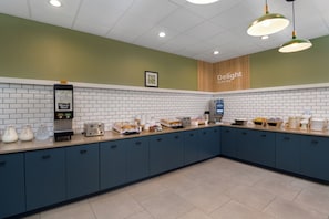 A breakfast bar with a coffee machine, toaster, and various food items. - Spark by Hilton Orangeburg (Orangeburg)