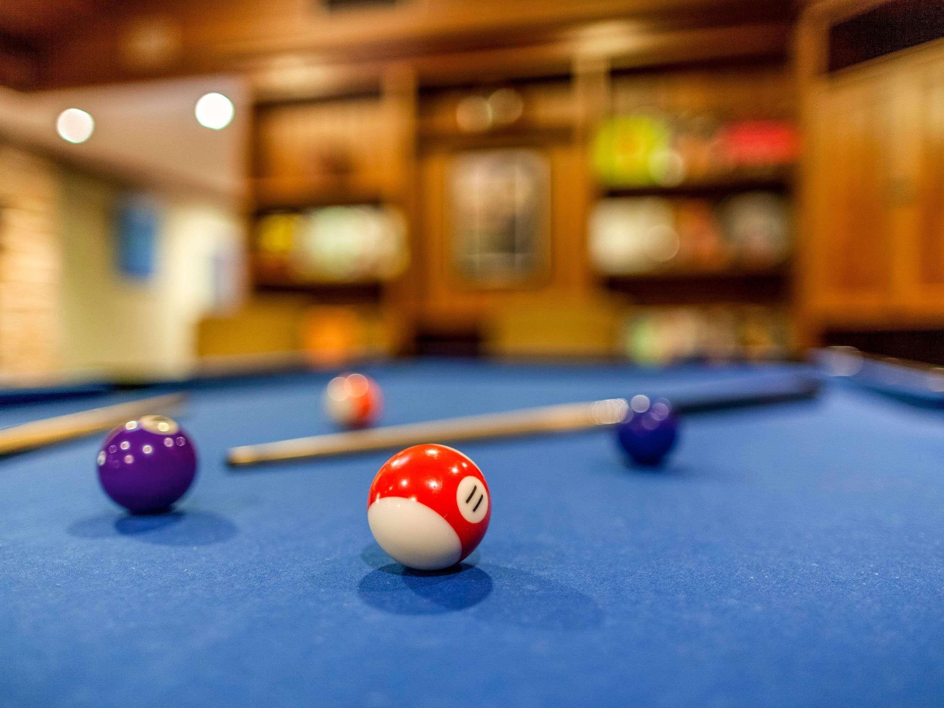 A pool table with balls in focus and a blurred background.