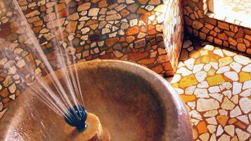 A stone mosaic floor with a central water feature.
