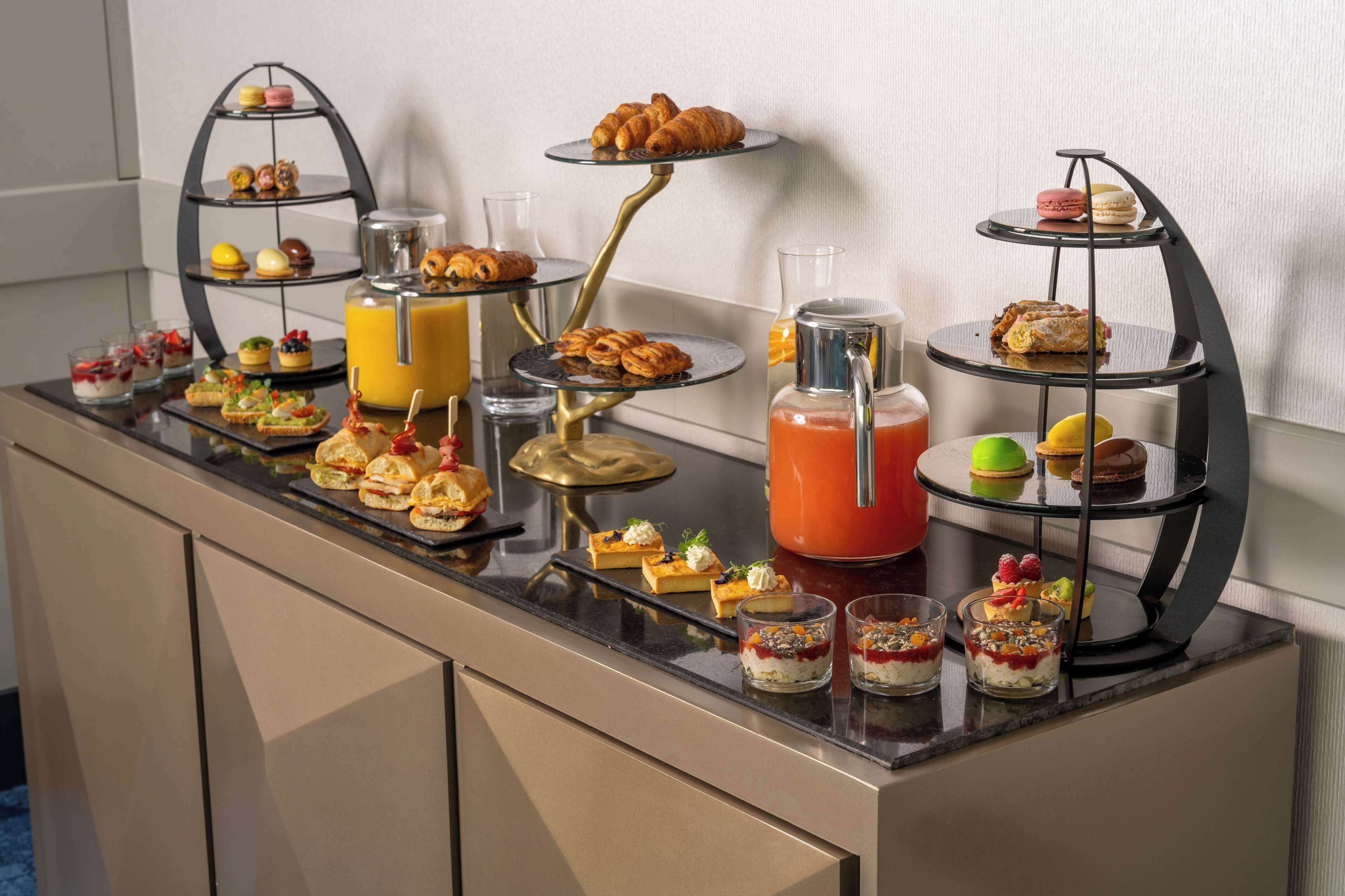 A buffet with various desserts and beverages.