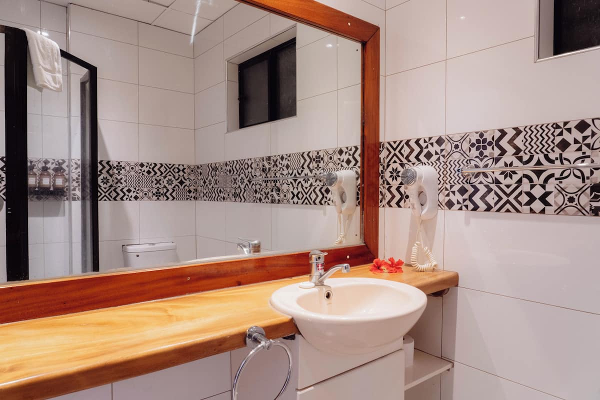 oceanfront king or twin room with balcony | bathroom | shower, rainfall showerhead, hair dryer, towels