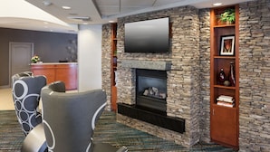 A lobby with a stone fireplace, a flat-screen TV, and a reception desk. - Residence Inn by Marriott Dothan (Dothan)