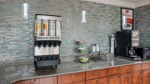 A modern kitchen with a coffee machine, a water dispenser, and a coffee maker. - Econo Lodge Lake Charles University Area (Lake Charles)