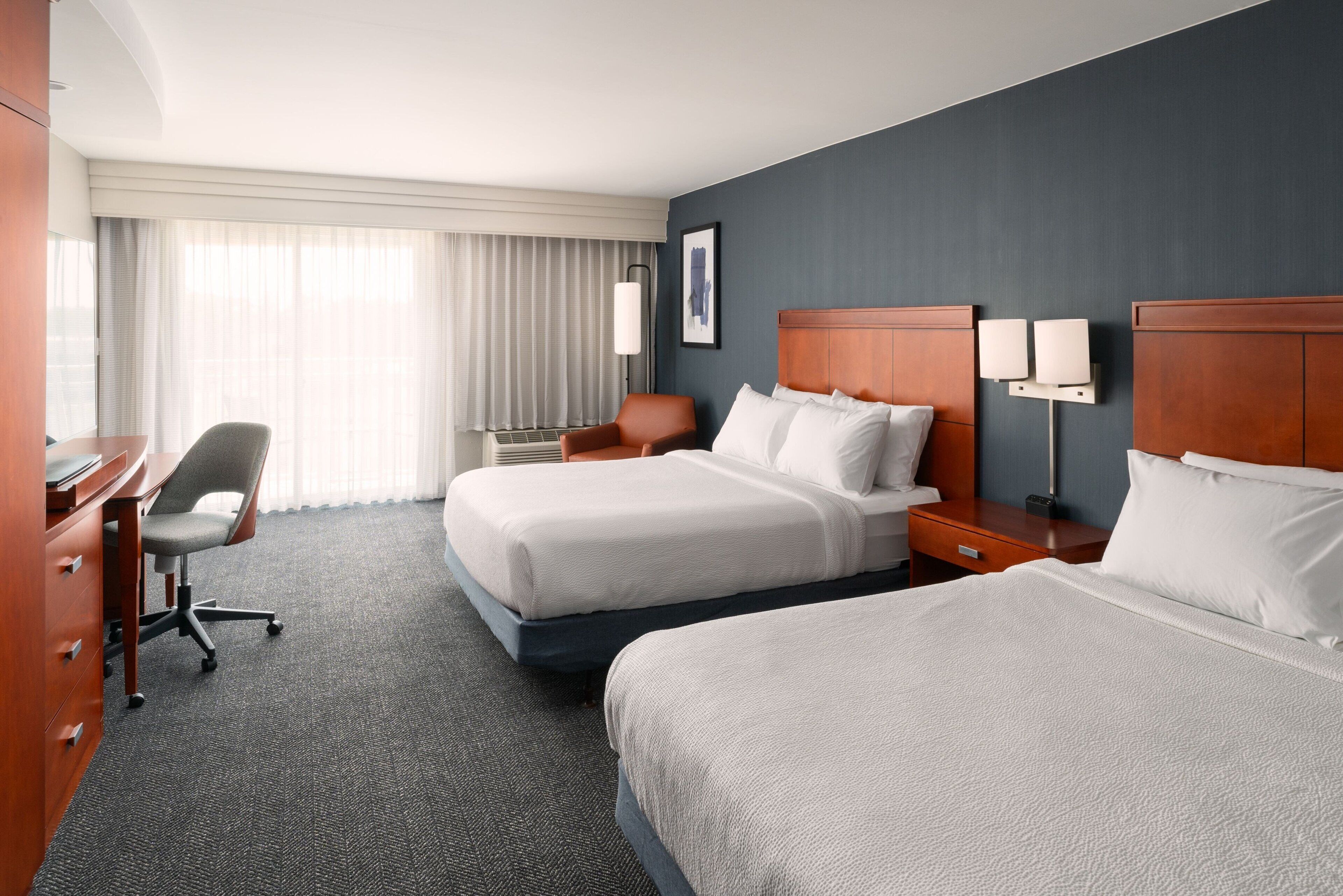 hypo-allergenic bedding, desk, laptop workspace, blackout curtains