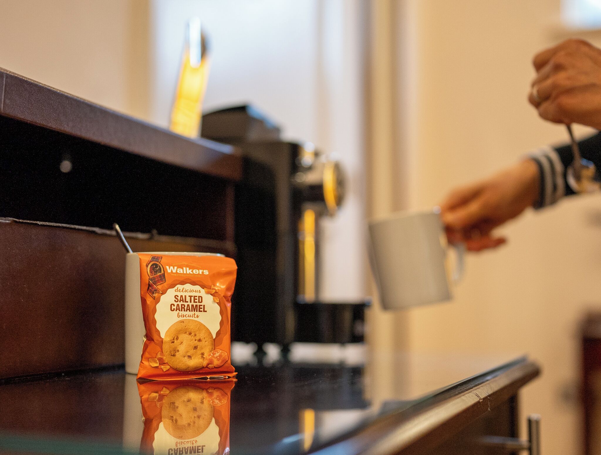 A bag of Walkers salted caramel biscuits on a table.