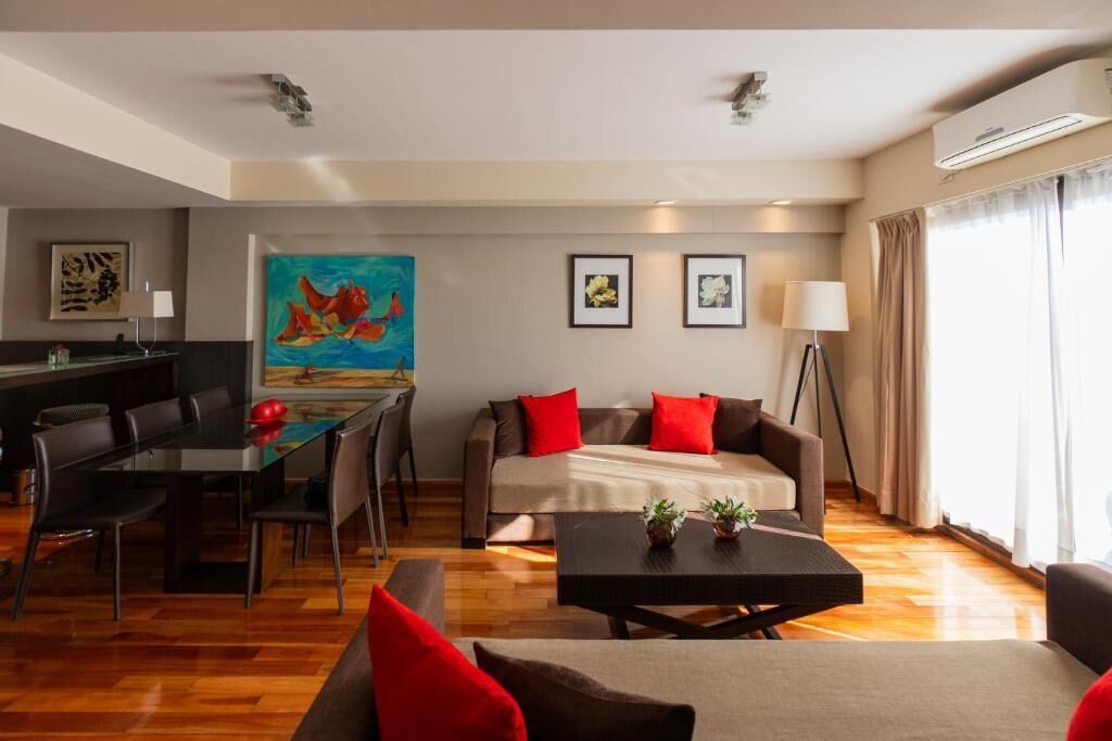 A modern living room with a sofa, a dining table, and a coffee table.