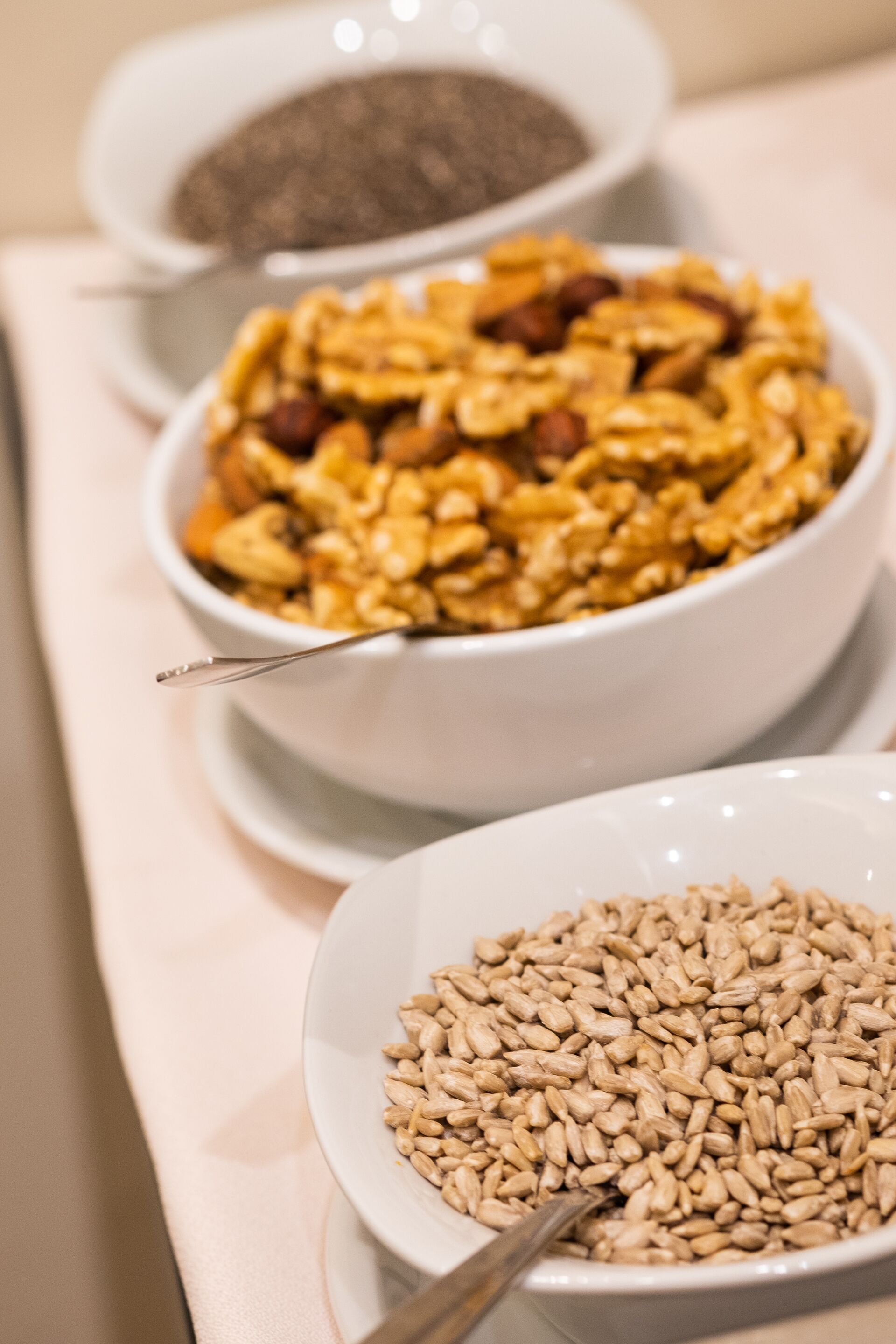 Three bowls of different food items on a table.
