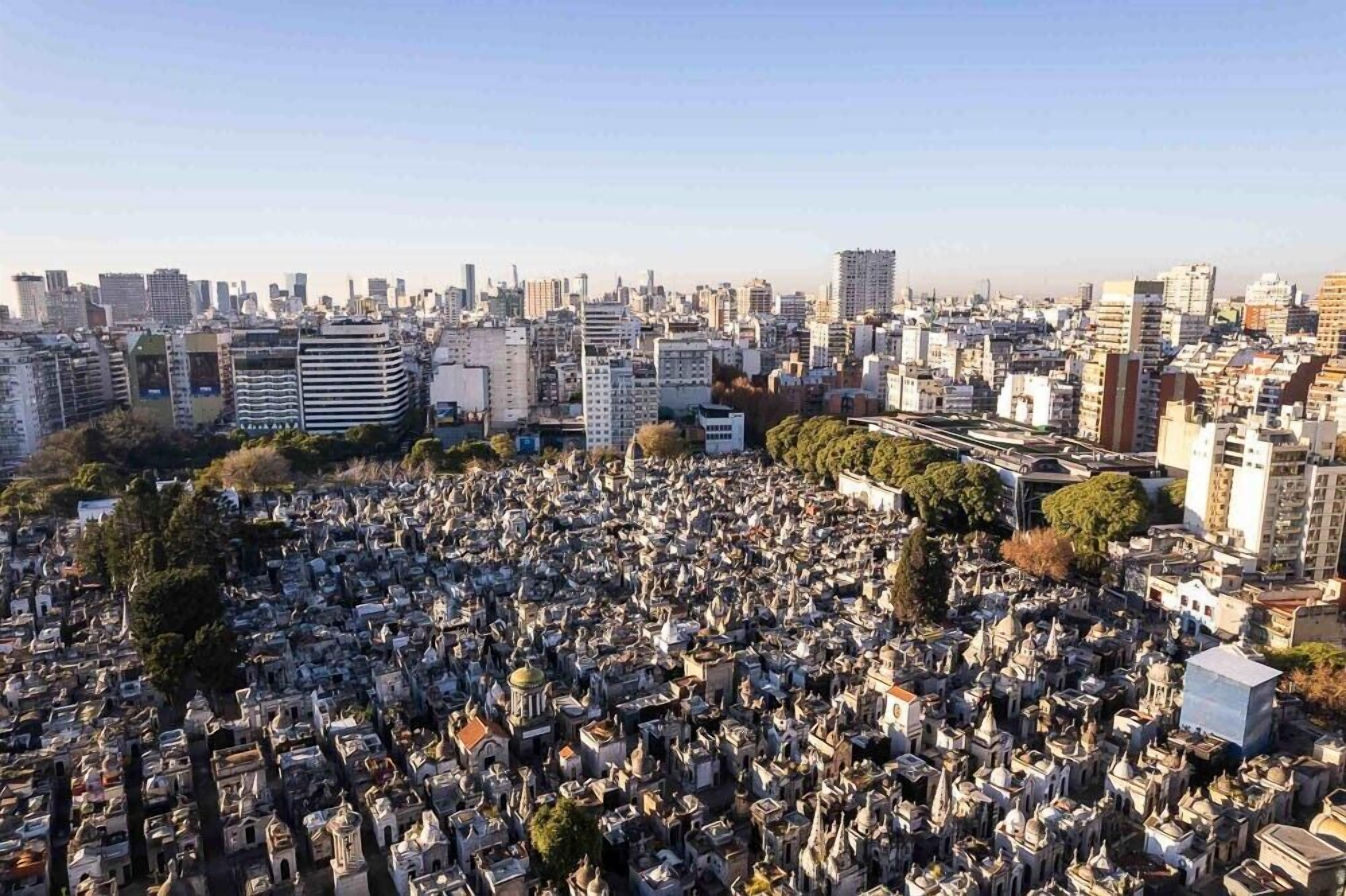 A densely packed cemetery surrounded by urban buildings.