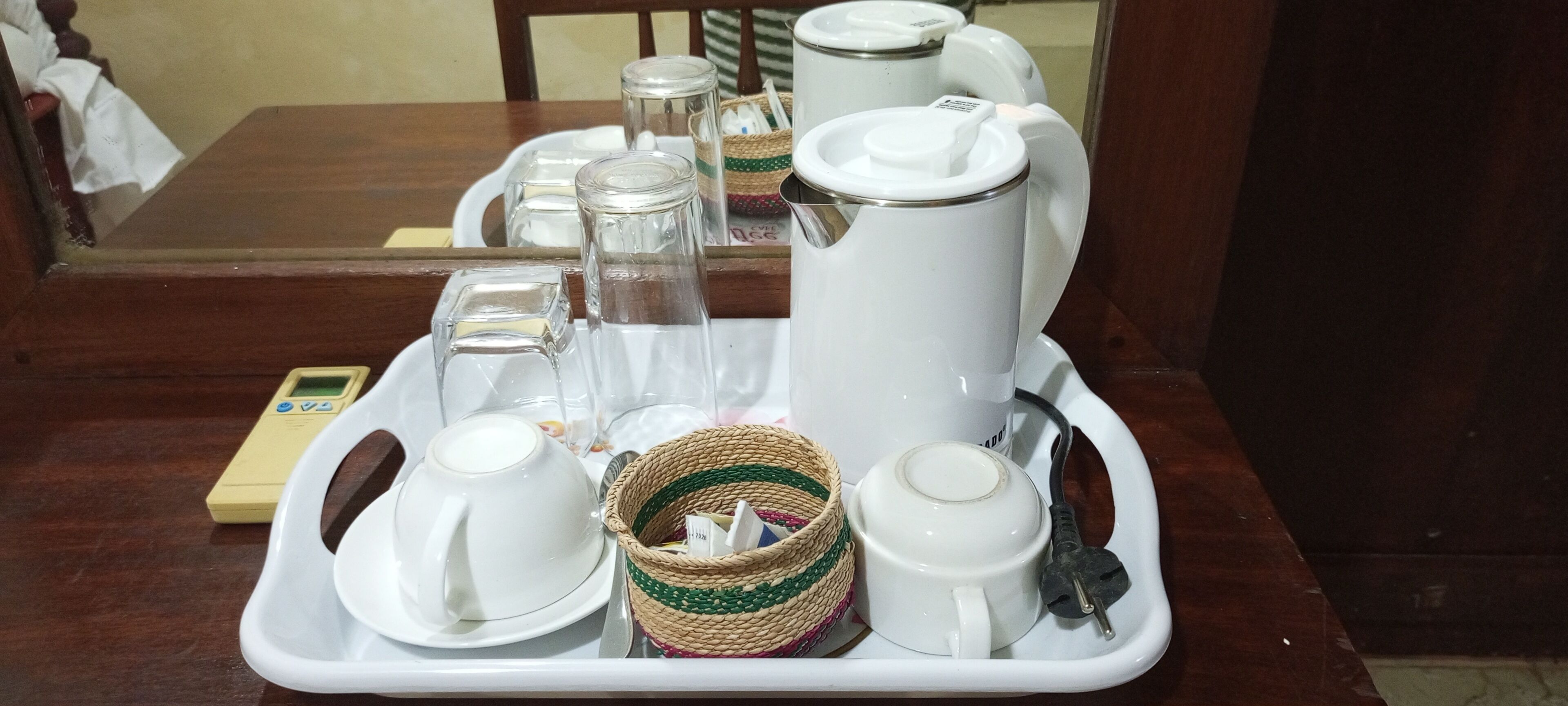 A tray with a tea set including a teapot, cups, and a sugar bowl.