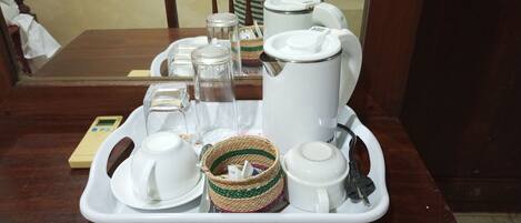 A tray with a tea set including a teapot, cups, and a sugar bowl.