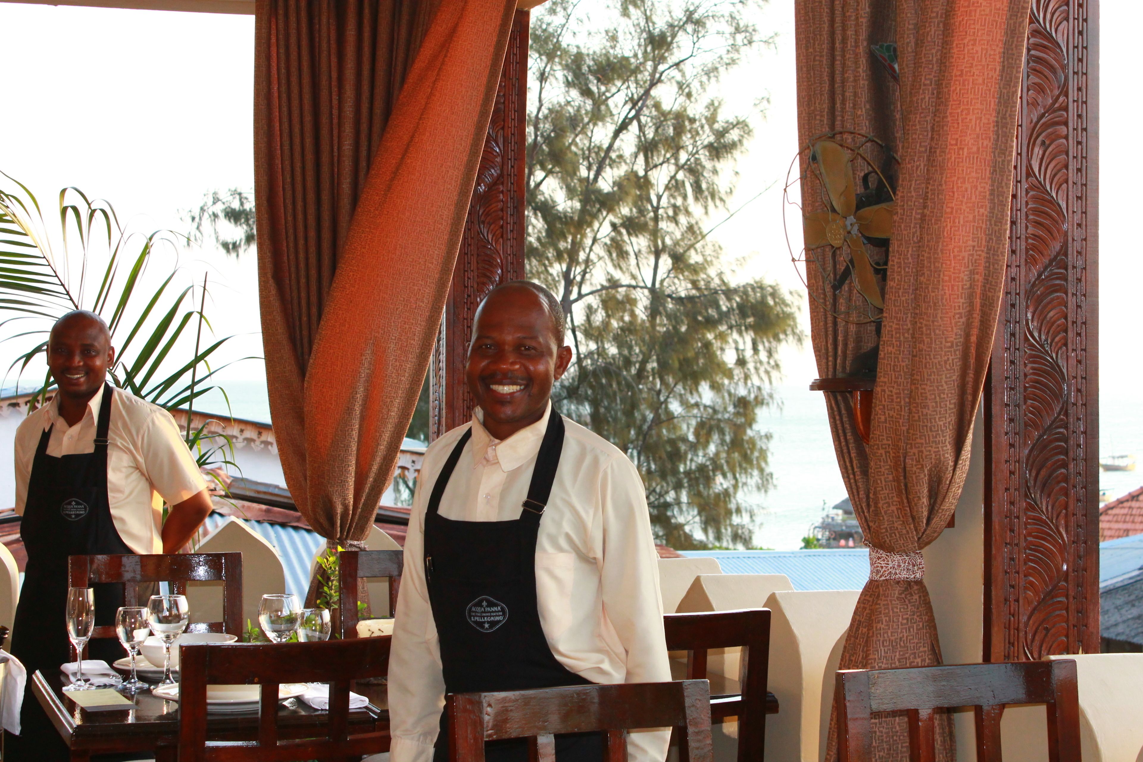A restaurant with wooden furniture and curtains.