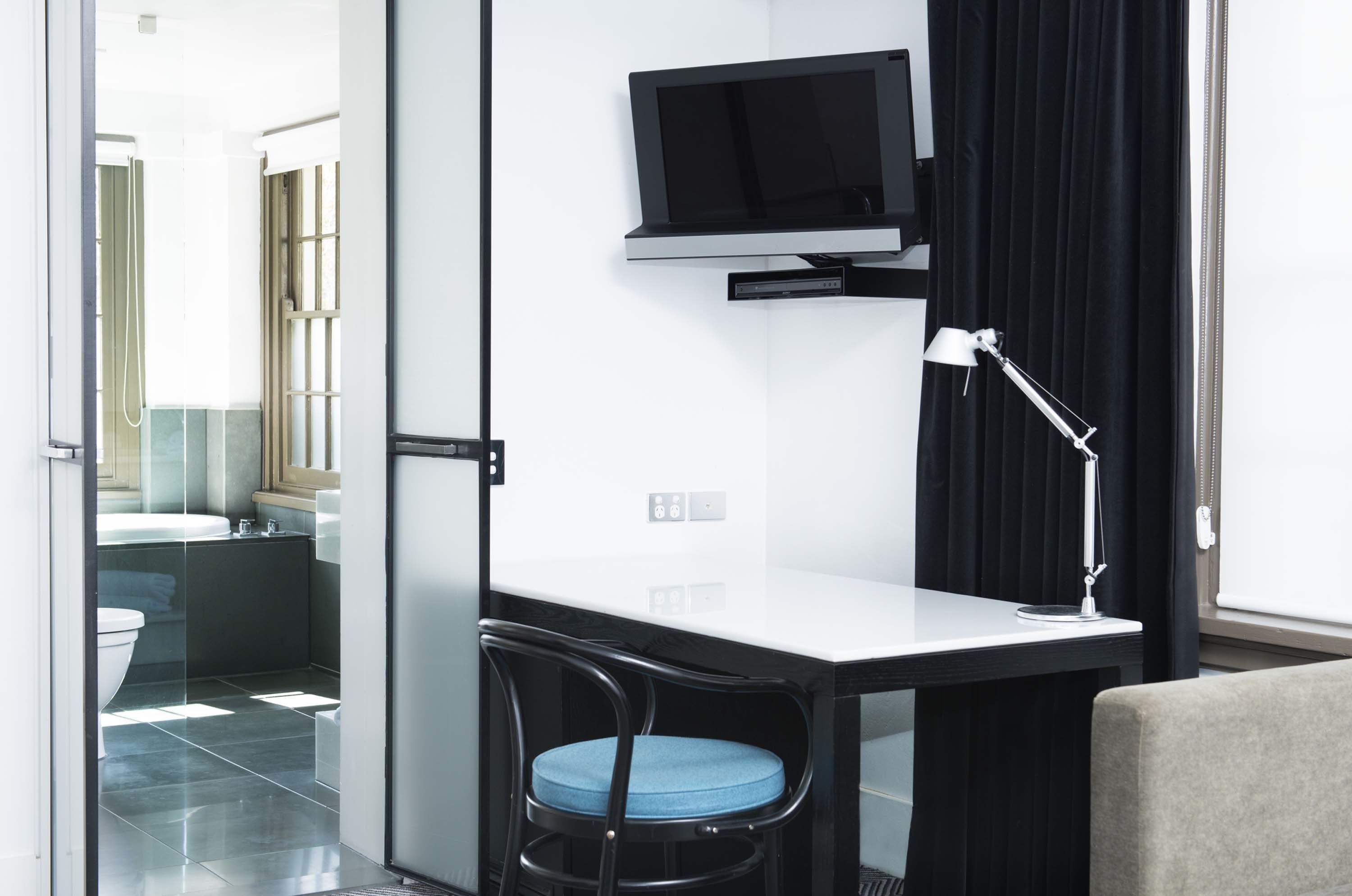 A modern bathroom with a toilet, sink, and shower.
