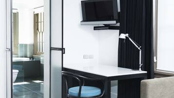 A modern bathroom with a toilet, sink, and shower.