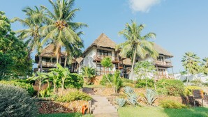 A resort with multiple buildings, a stone staircase, and lush tropical vegetation. - Sultan Sands Island Resort & Spa (Kiwengwa)