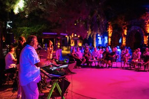 An outdoor event with a stage and seated audience.