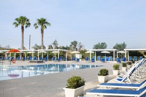 Alberca al aire libre, sombrillas en la alberca y camastros 