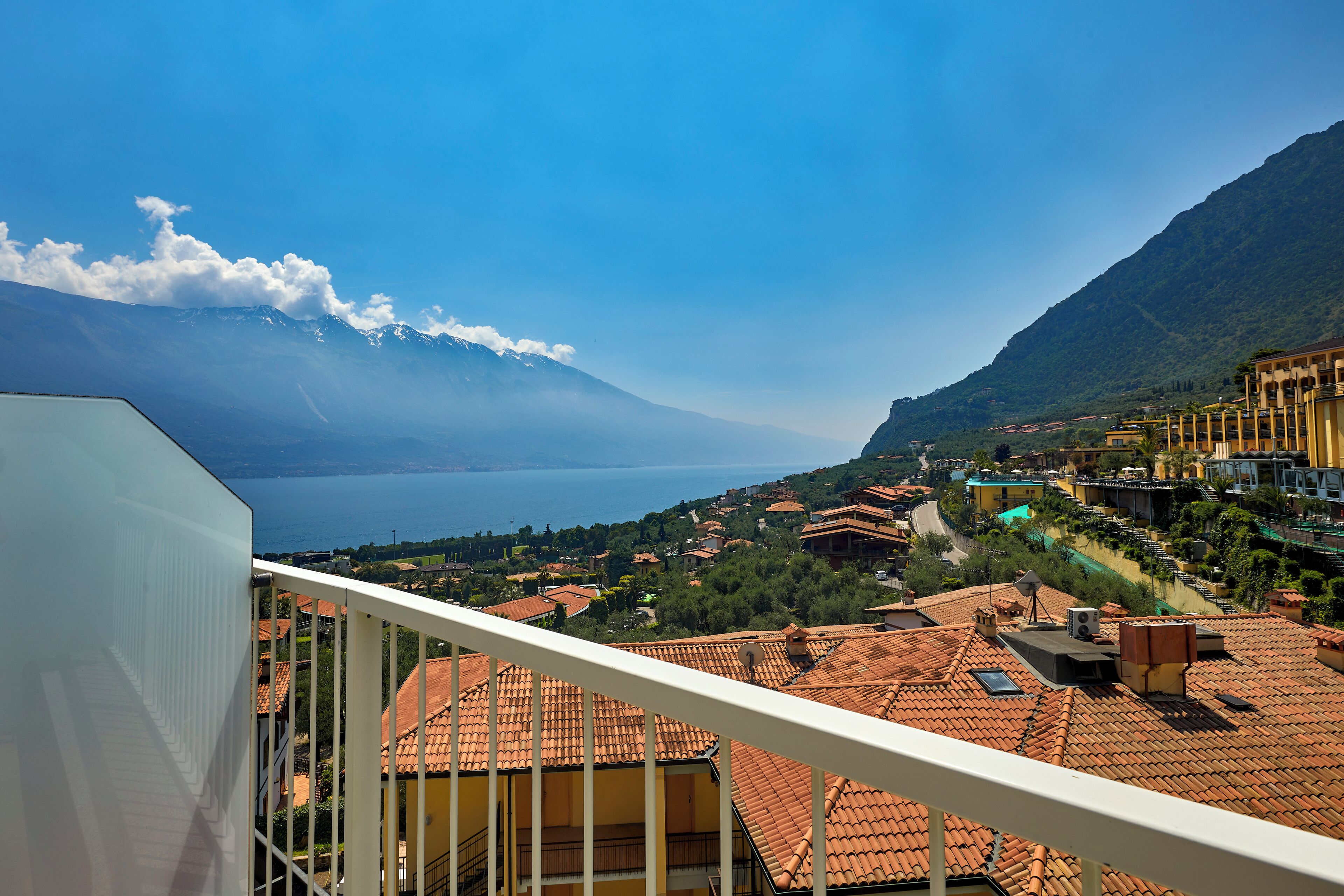 A balcony with a view of a lake and mountains.