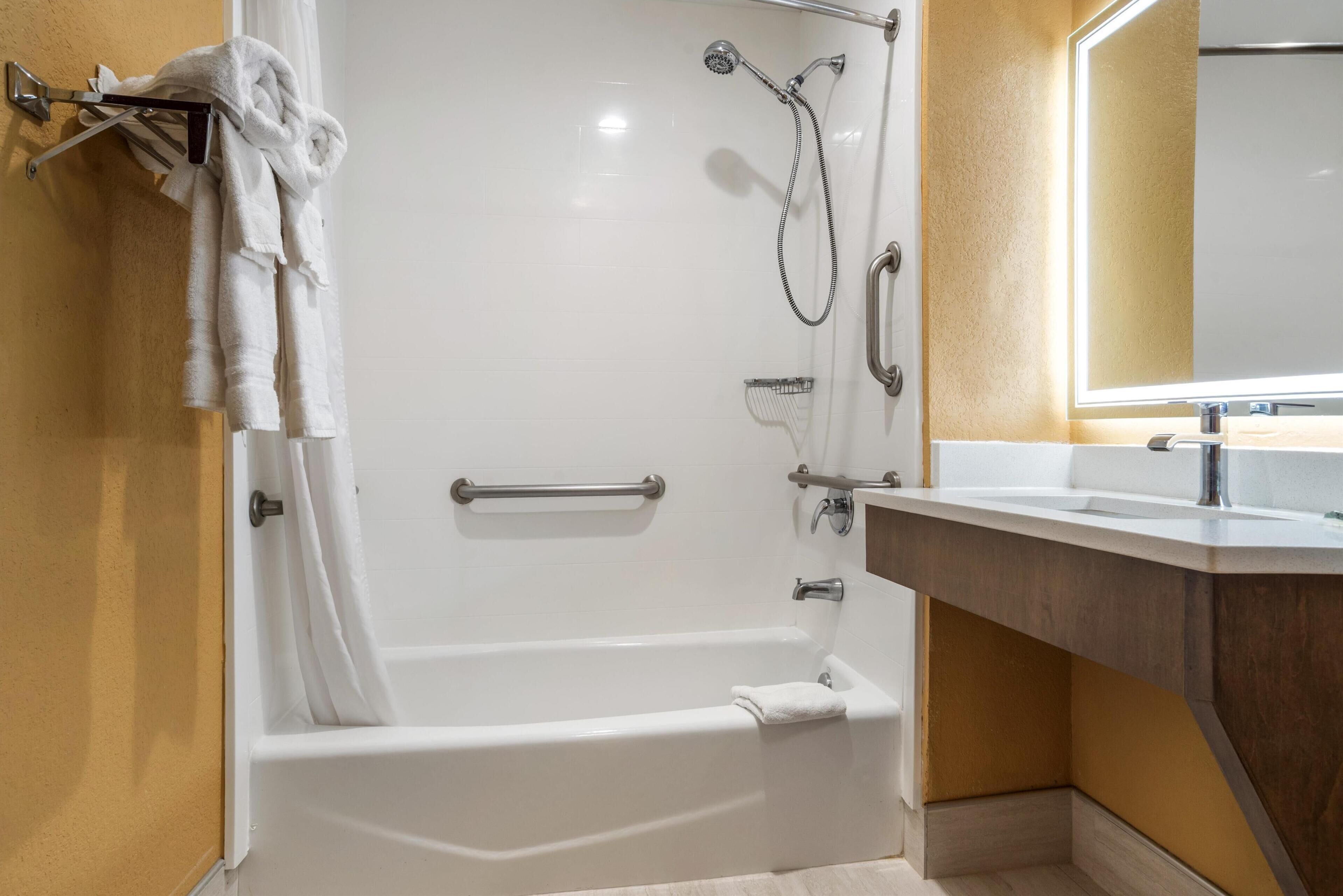 suite, 1 king bed, accessible, refrigerator & microwave | bathroom | combined shower/bathtub, hair dryer, towels