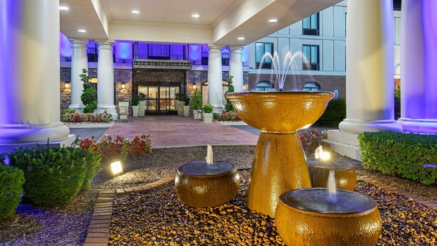 A hotel entrance with a central fountain, columns, and a stone facade. - Holiday Inn Express Mt. Juliet by IHG (Mount Juliet)