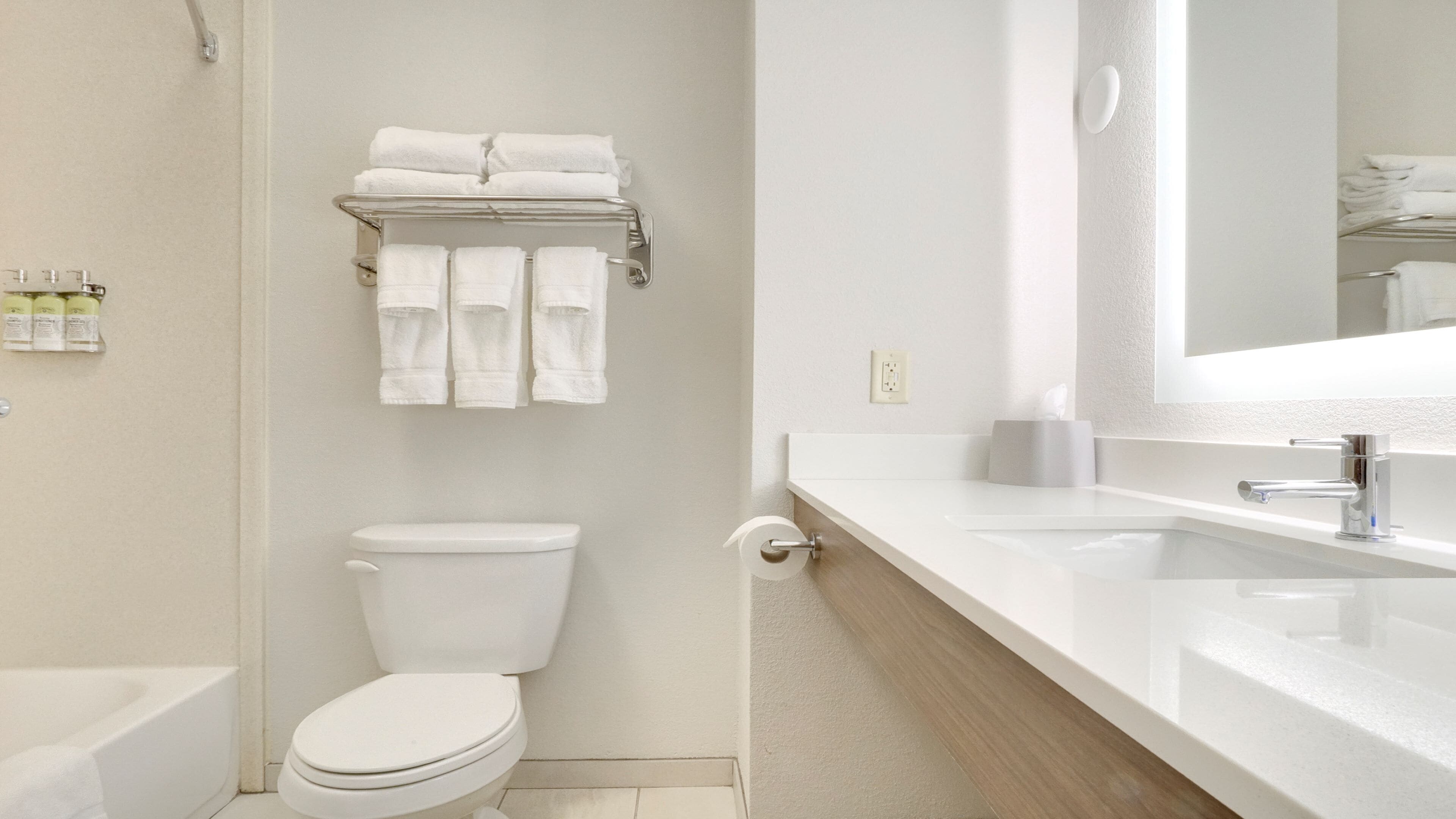 Un baño moderno con inodoro, lavabo y toallero.