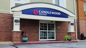 A hotel entrance with a sign reading "CANDLEWOOD SUITES" and the address "2270".
