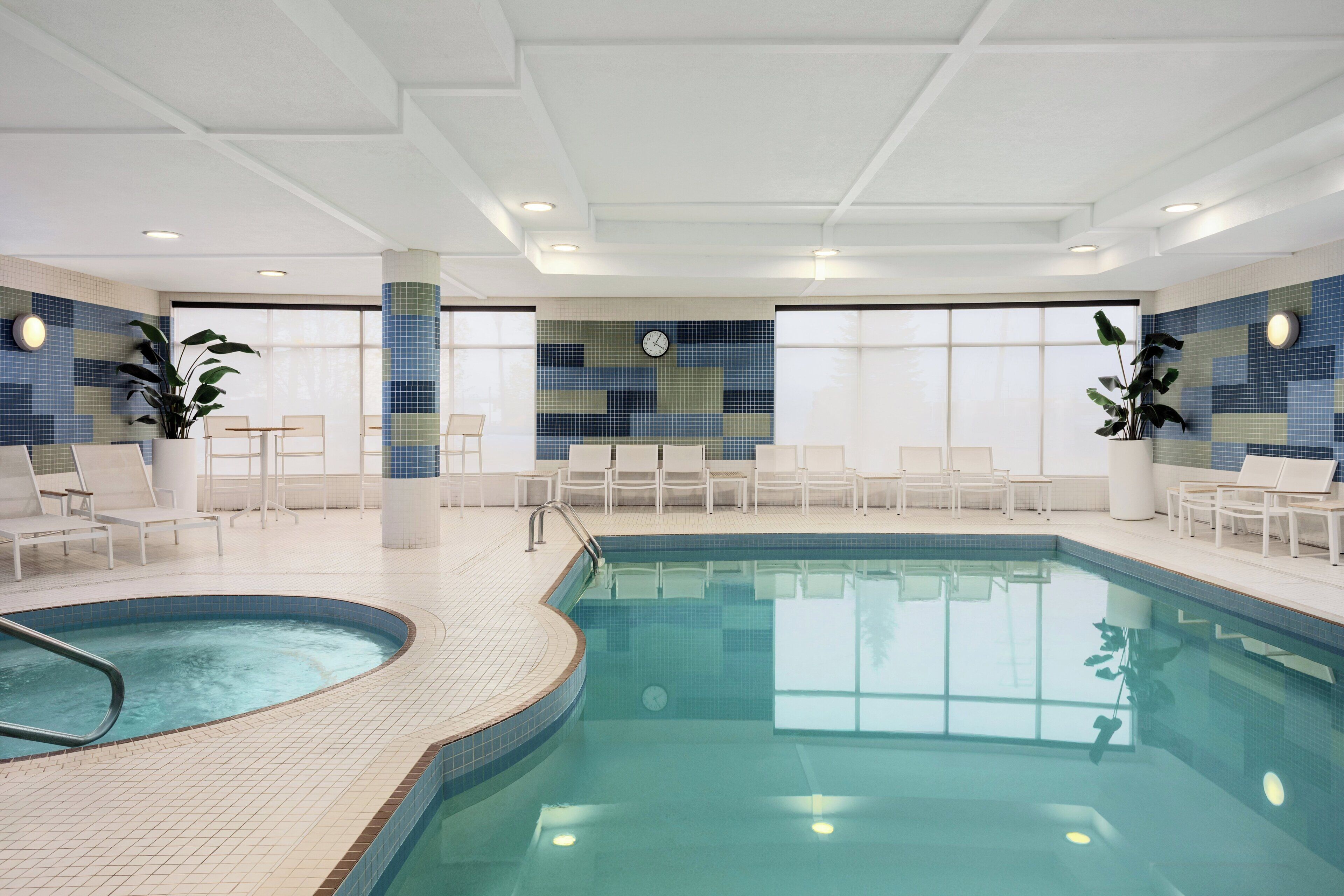 Una piscina techada, sillones reclinables de piscina