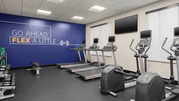 A gym with treadmills, ellipticals, and weight machines.