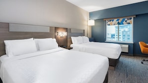 A hotel room with two beds, a nightstand, a lamp, and a view of the city through the window. - Holiday Inn Express & Suites Vaughan-Southwest by IHG (Vaughan)