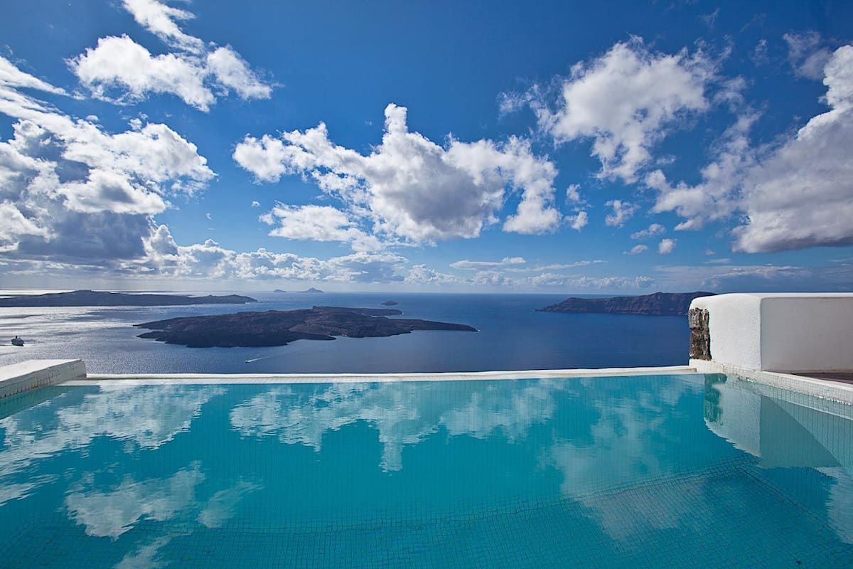 An infinity pool with a view of the sea and islands.