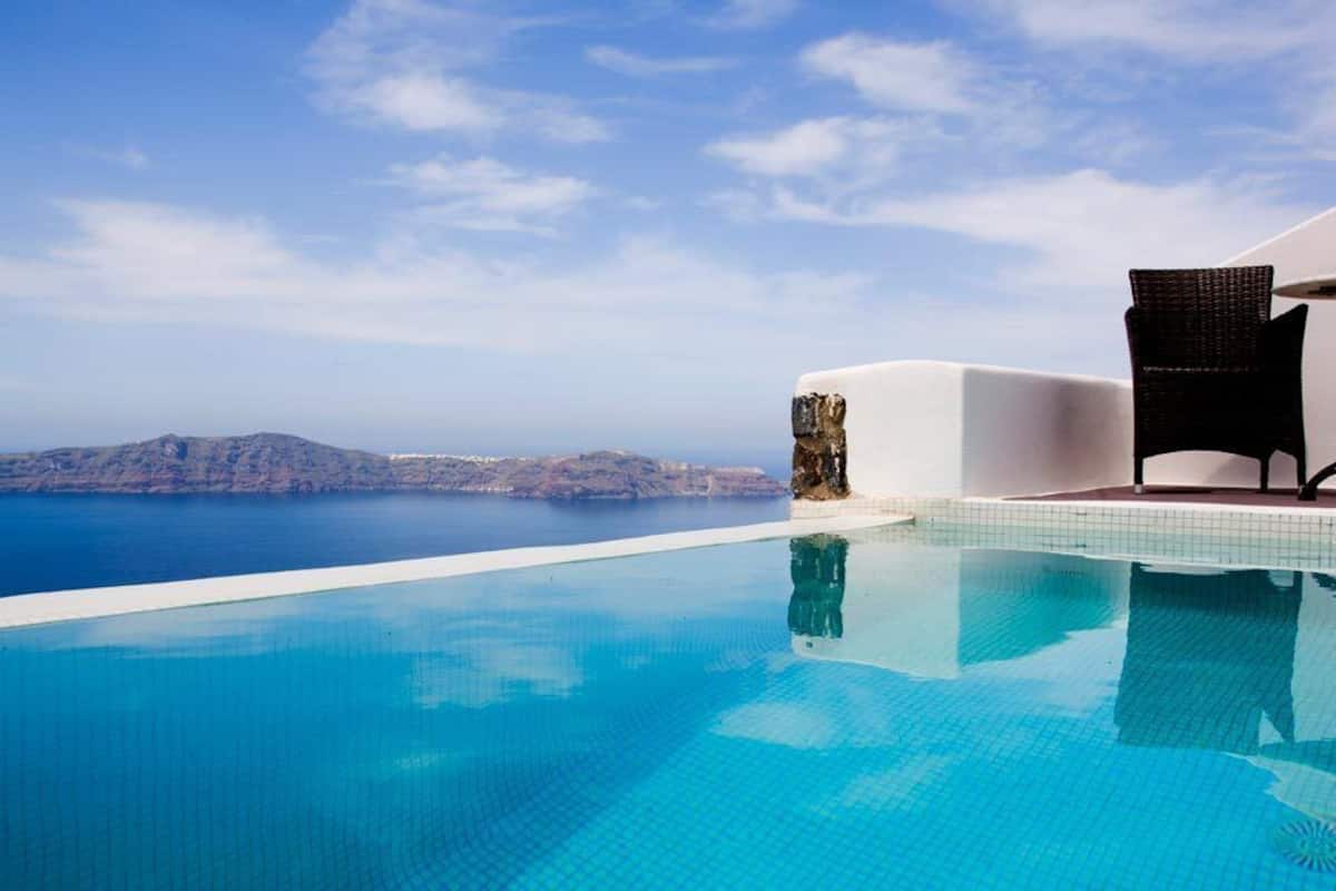 An infinity pool with a clear view of the sea and distant mountains.