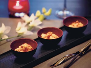 Three bowls of food on a tray with chopsticks beside them. - Pemako Thimphu (Thimphu)