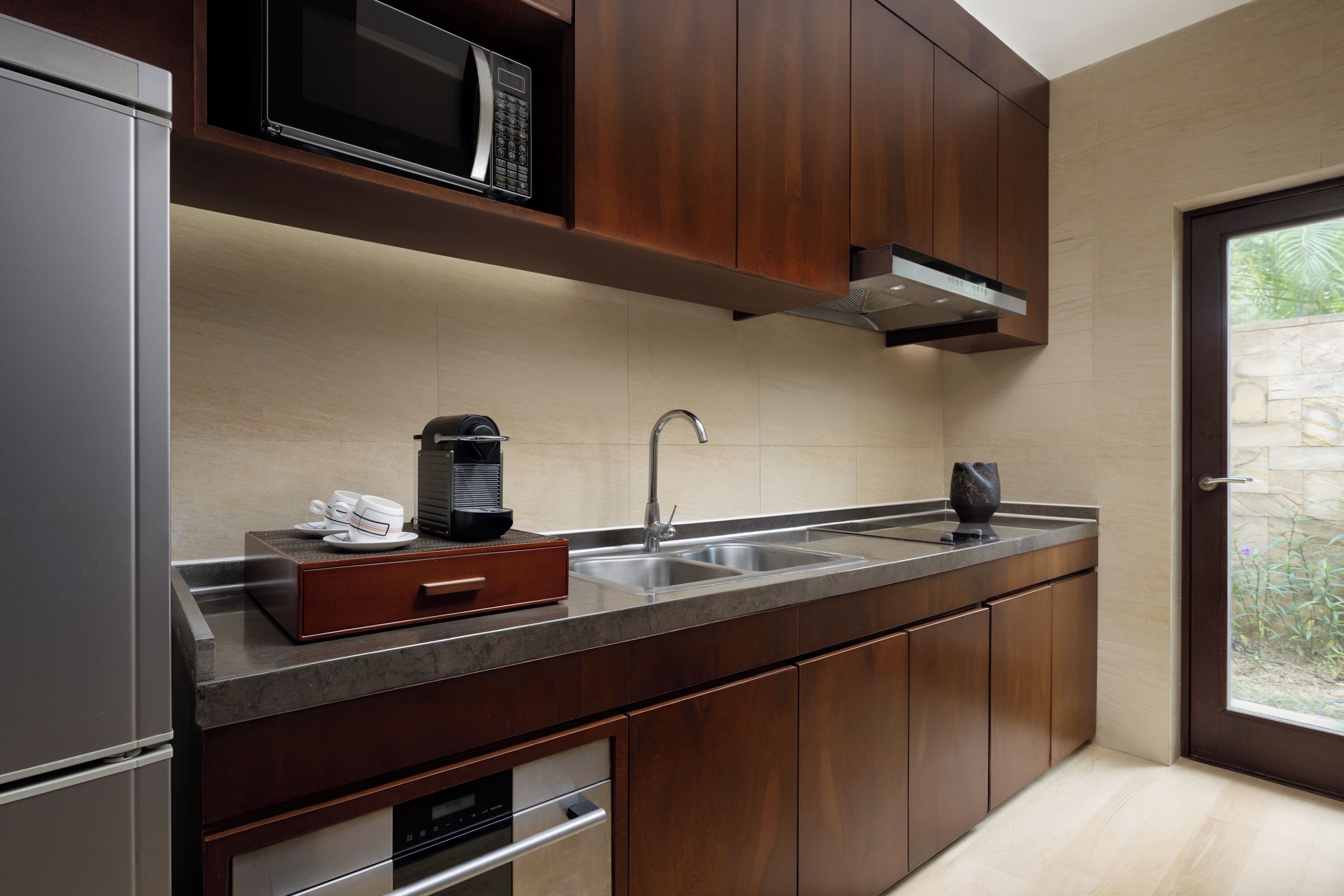 A modern kitchen with stainless steel appliances, a built-in microwave, and a double sink.