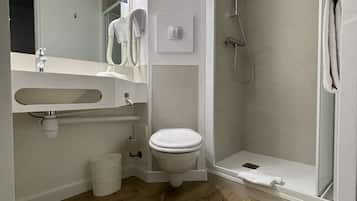 Une salle de bain moderne avec un plancher en bois, des toilettes, un lavabo et une douche.