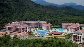 A resort with multiple buildings, a swimming pool, and a water park.