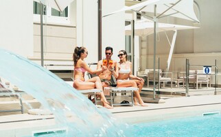 Seasonal outdoor pool, open 10:00 AM to 6:00 PM, pool umbrellas