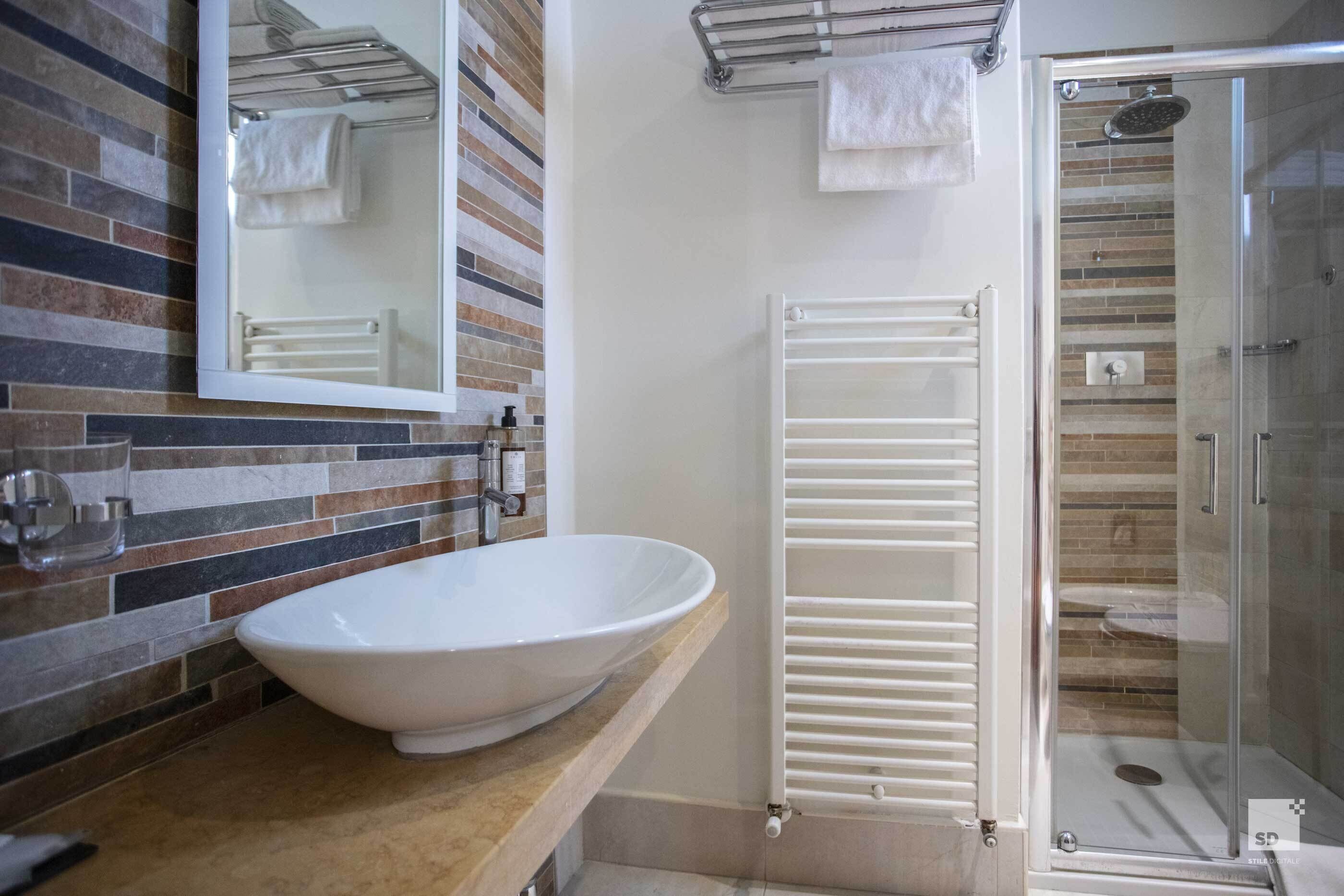 shower, hair dryer, bidet, towels