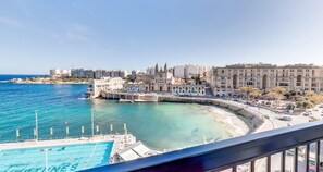 A coastal cityscape with a prominent church, a marina, and modern buildings. - St Julian's Bay Hotel (St. Julian's)