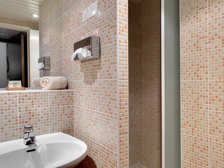 A bathroom with a sink, a mirror, and a towel rack.