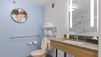 A modern bathroom with a toilet, sink, and towel rack.